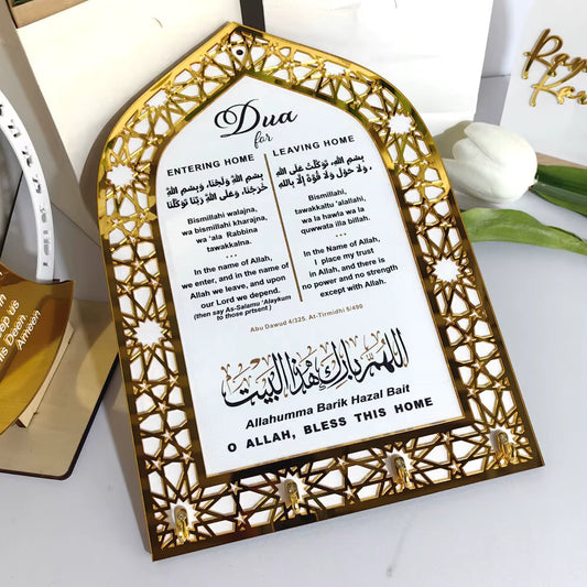 Decorative wall hook with Islamic prayer text and key holders on a white surfice