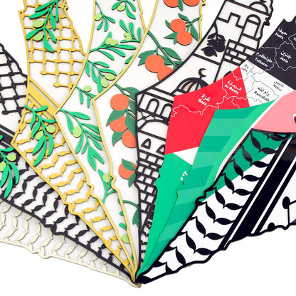 Collection of colorful wooden maps of palestine with geometric and nature-themed designs.