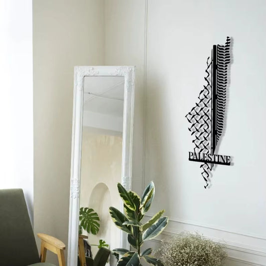 Decorative wall art with 'Palestine' on a white wall next to a mirror.