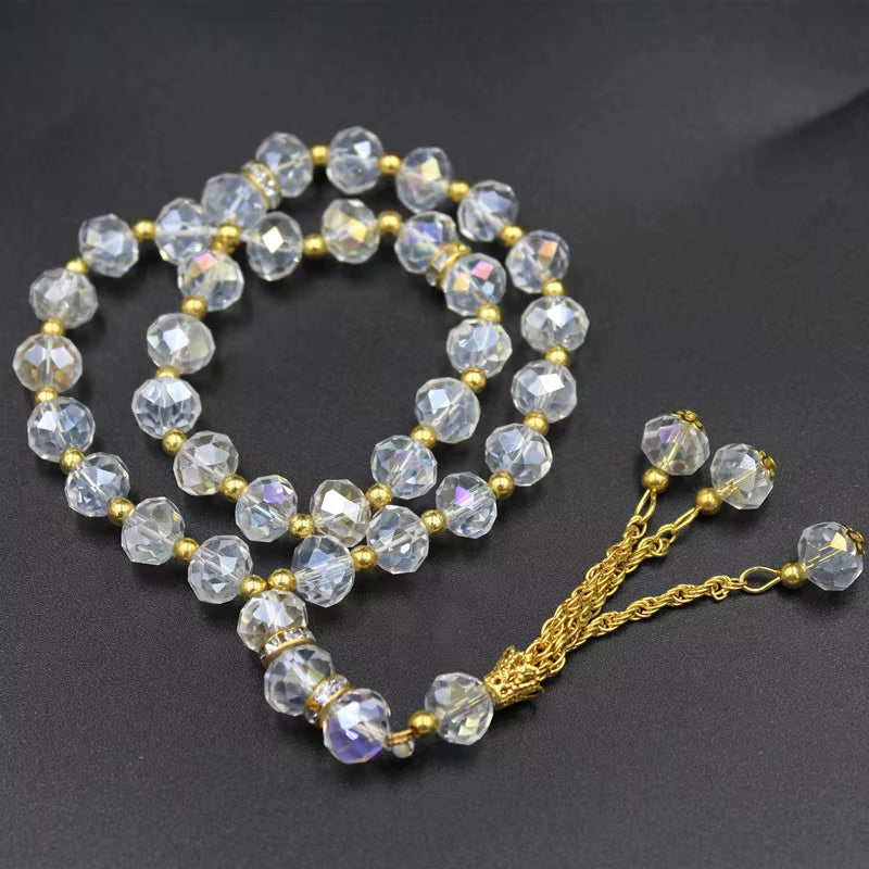 prayer beads with faceted beads and gold chain on a dark background