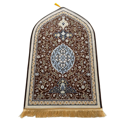Decorative prayer rug with intricate patterns and tassels on a white background