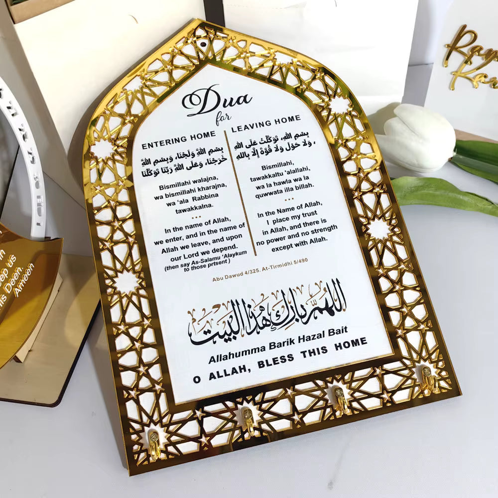 Decorative wall hook with Islamic prayer text and key holders on a white surfice